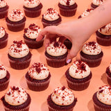 Vegan Red Velvet Cupcakes with creamy plant-based vanilla icing and red velvet crumb, freshly baked by Crumbs & Doilies.